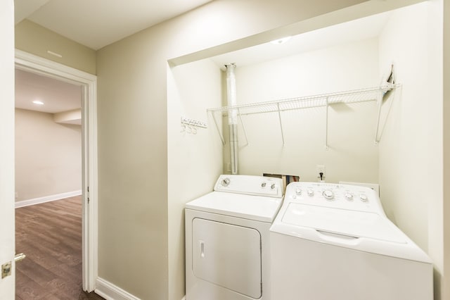 clothes washing area featuring independent washer and dryer and hardwood / wood-style flooring