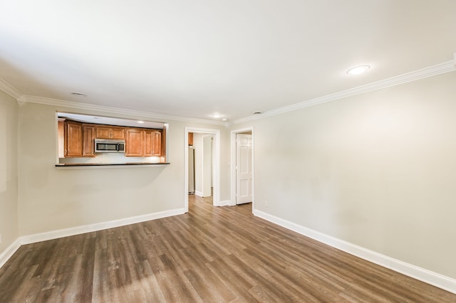 unfurnished living room with ornamental molding and hardwood / wood-style floors