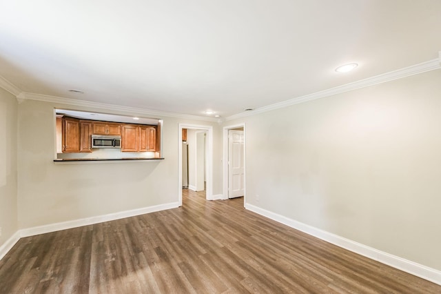 unfurnished living room with ornamental molding, recessed lighting, baseboards, and wood finished floors