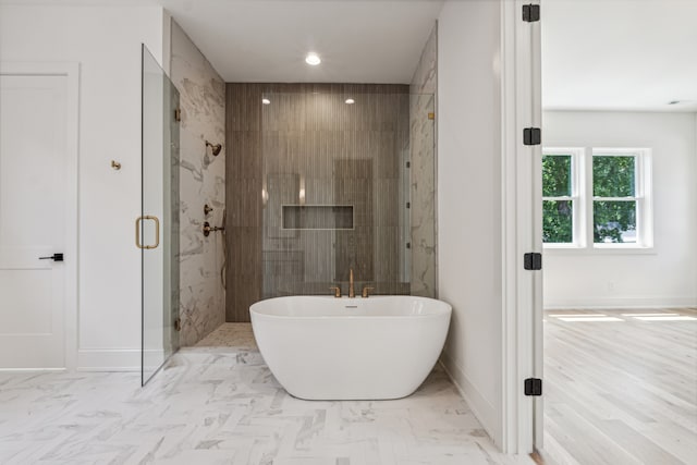 bathroom with tile patterned flooring and separate shower and tub