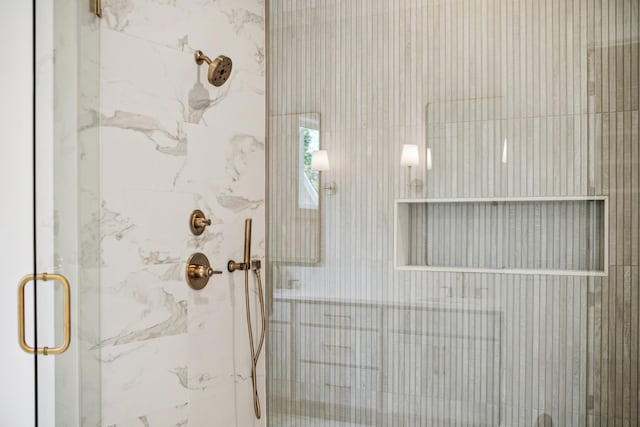 bathroom featuring a shower with shower door