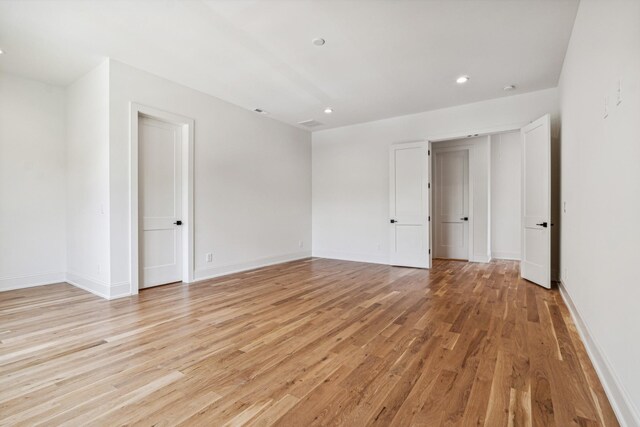 empty room with light hardwood / wood-style floors