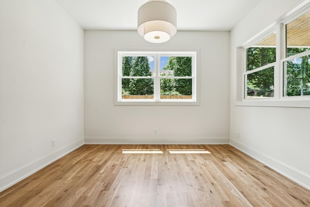 unfurnished room with light hardwood / wood-style floors