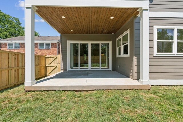 back of house with a lawn and a patio area