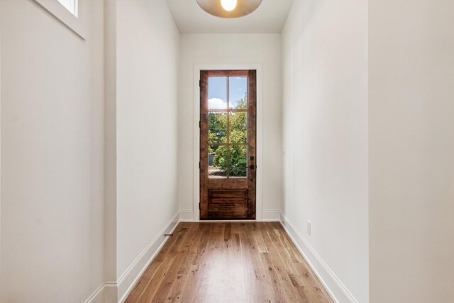 doorway to outside with light wood-type flooring