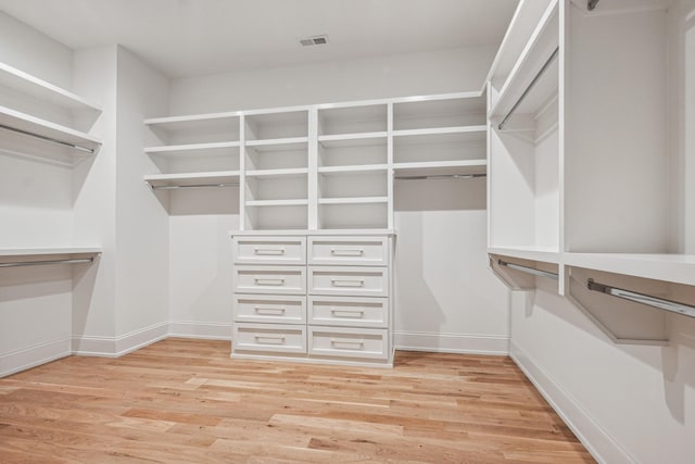 spacious closet with light hardwood / wood-style flooring