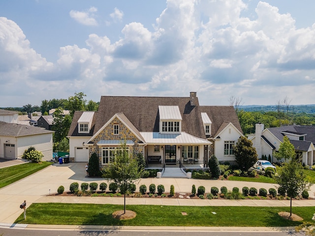 view of front of property with covered porch and a garage