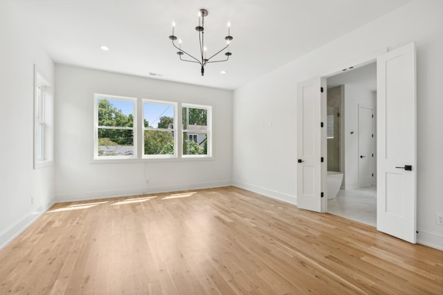 interior space with an inviting chandelier and light wood-type flooring