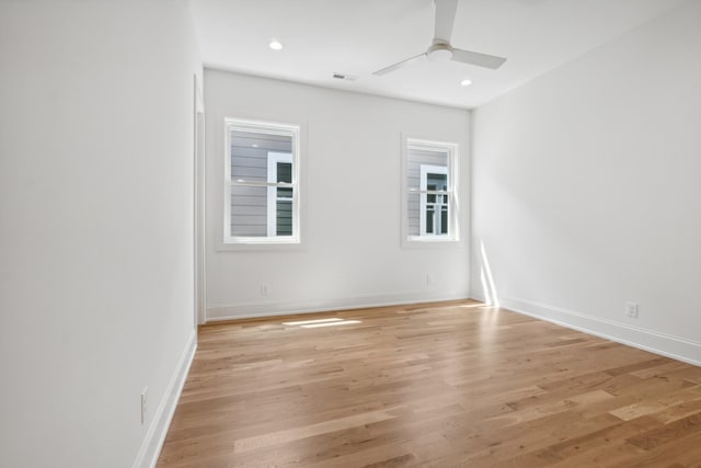 empty room with ceiling fan and light hardwood / wood-style floors