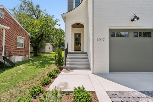 entrance to property with a yard and a garage