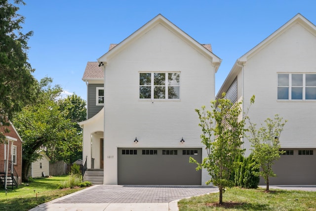 view of front of home featuring a garage and a front lawn