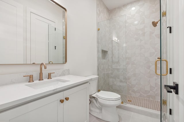 bathroom featuring tile patterned flooring, vanity, toilet, and walk in shower