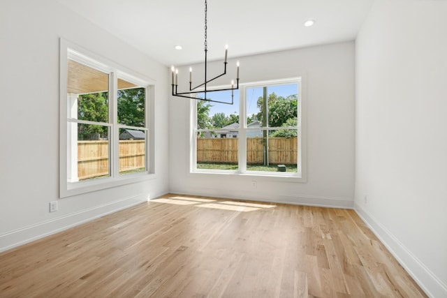 unfurnished dining area with a wealth of natural light and light hardwood / wood-style flooring