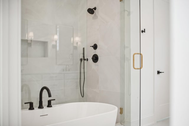 bathroom featuring separate shower and tub