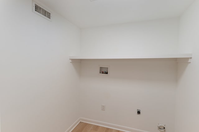 clothes washing area featuring electric dryer hookup, hookup for a washing machine, and wood-type flooring