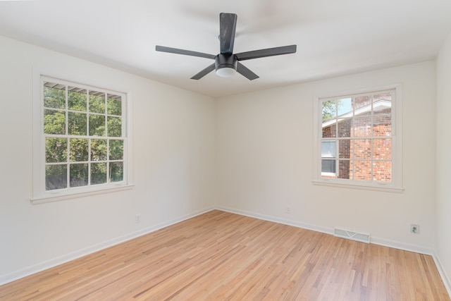 empty room with ceiling fan and light hardwood / wood-style floors