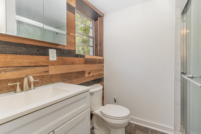 bathroom featuring vanity, toilet, and hardwood / wood-style floors