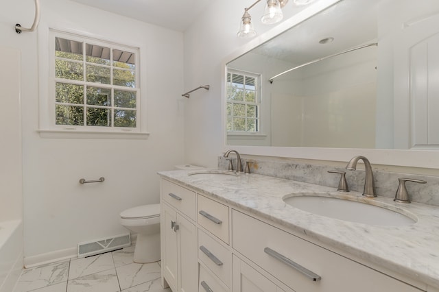 full bathroom with double sink vanity, toilet, tile patterned flooring, and a wealth of natural light