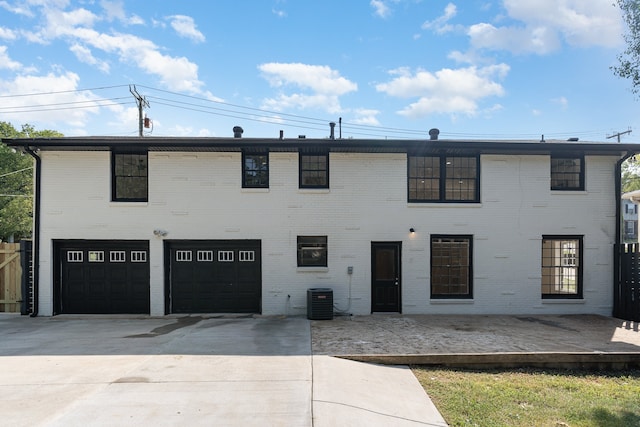 view of front facade featuring cooling unit, a garage, and a deck