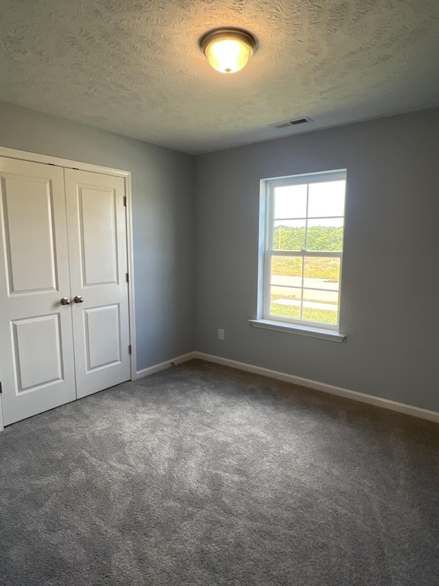 unfurnished bedroom featuring a closet, carpet flooring, and baseboards