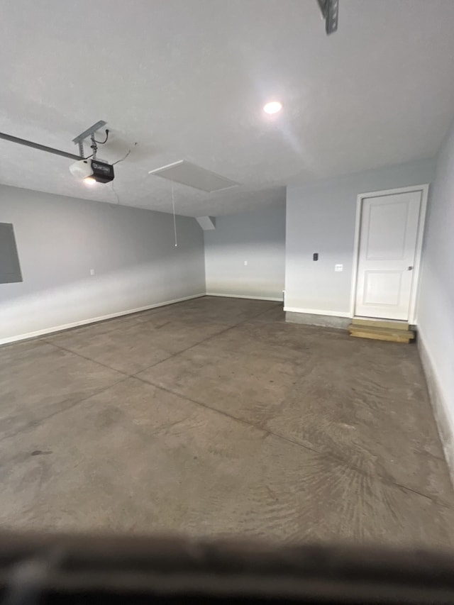 garage with recessed lighting, baseboards, and a garage door opener