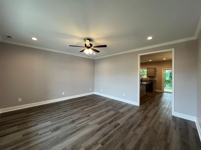 empty room with ornamental molding, dark wood-type flooring, and ceiling fan