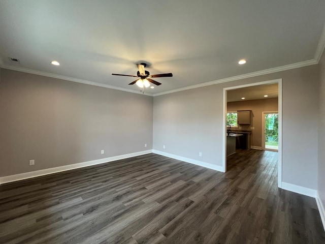 spare room featuring visible vents, baseboards, dark wood-style flooring, and ceiling fan