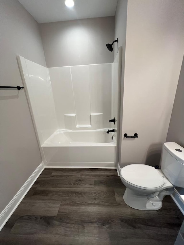 full bathroom featuring  shower combination, toilet, wood finished floors, and baseboards