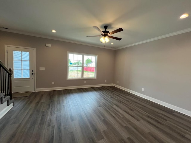 unfurnished living room with ceiling fan, dark hardwood / wood-style floors, and crown molding