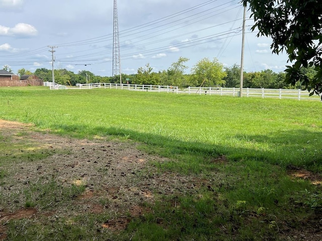 view of yard featuring a rural view and fence