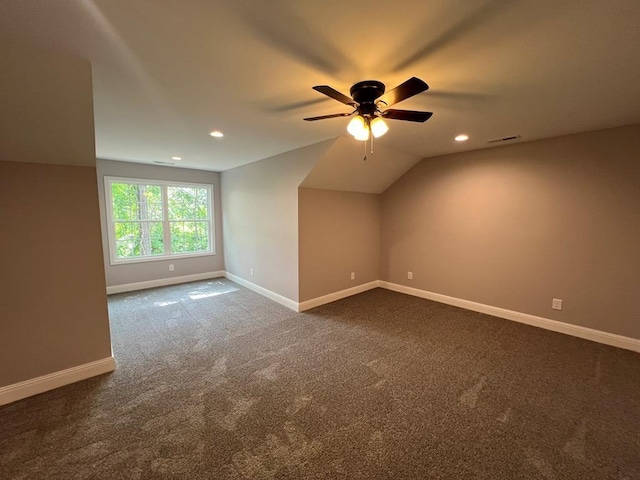 additional living space featuring baseboards, ceiling fan, dark carpet, vaulted ceiling, and recessed lighting