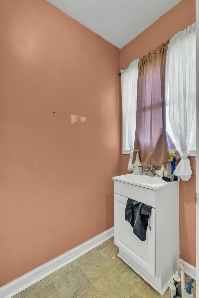 bathroom with tile patterned floors and vanity