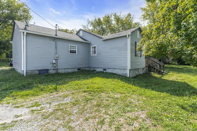 rear view of property featuring a yard