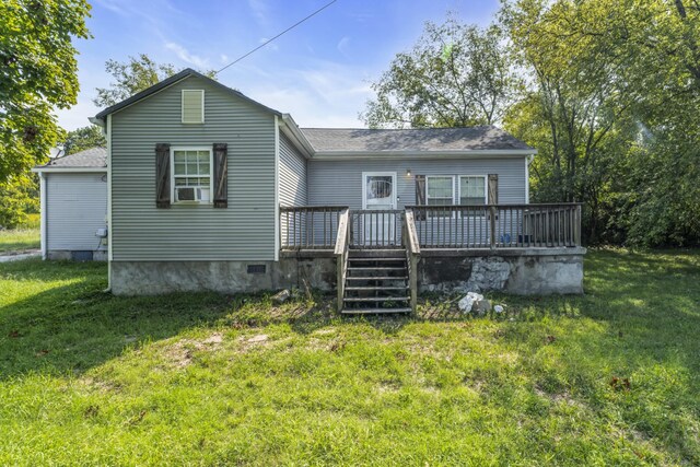 back of property featuring a lawn and a deck