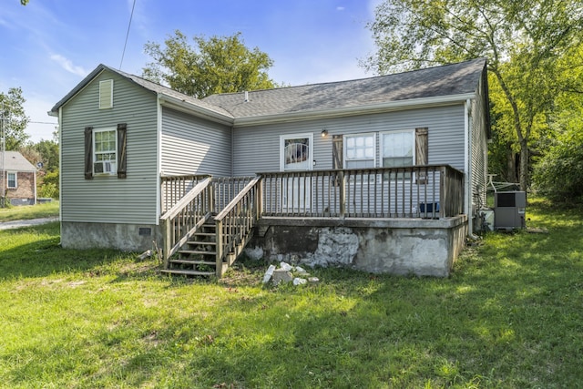 rear view of property with a yard and a deck