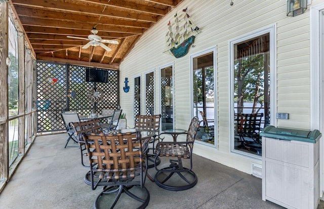 unfurnished sunroom featuring ceiling fan and vaulted ceiling