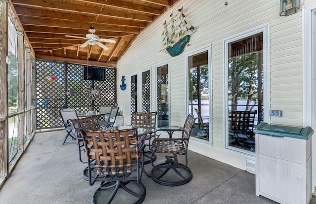 unfurnished sunroom featuring wooden ceiling, vaulted ceiling with beams, and ceiling fan