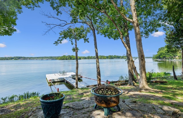 view of dock featuring a water view and an outdoor fire pit