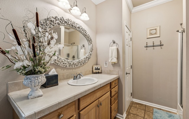 bathroom featuring vanity, crown molding, and tile patterned flooring