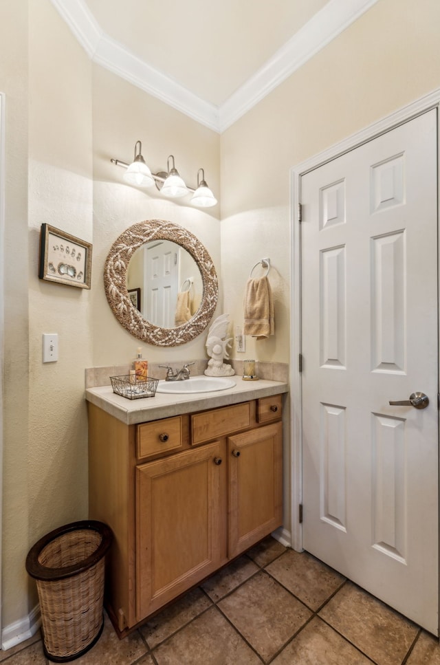 bathroom with tile patterned floors, ornamental molding, and vanity