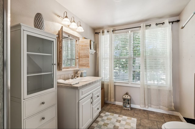 bathroom featuring vanity, tile patterned flooring, and toilet