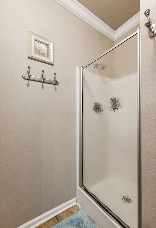 bathroom featuring walk in shower, ornamental molding, and tile patterned floors