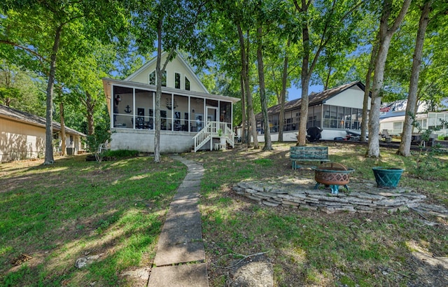 rear view of property featuring a sunroom