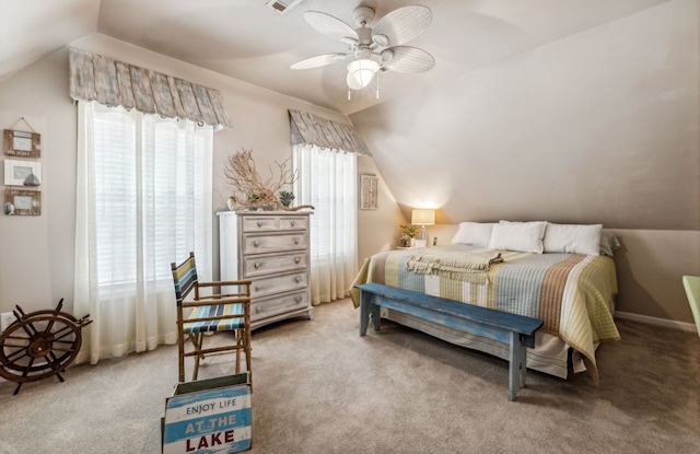 bedroom with lofted ceiling, light carpet, and multiple windows