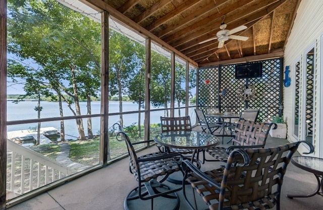 sunroom / solarium with ceiling fan, vaulted ceiling, a water view, and wood ceiling