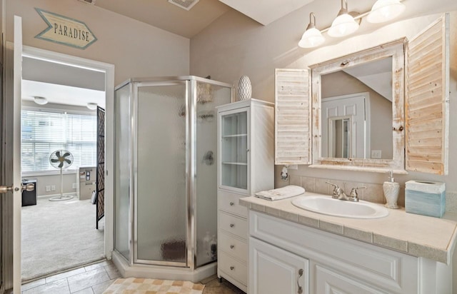 bathroom featuring visible vents, a shower stall, and vanity