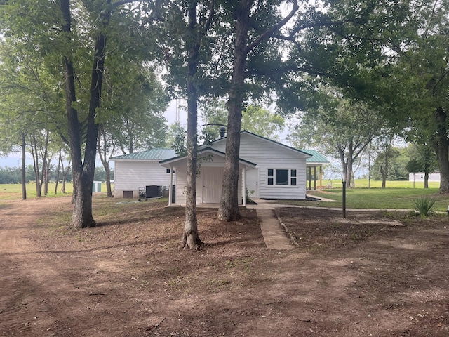 exterior space with a yard and central AC