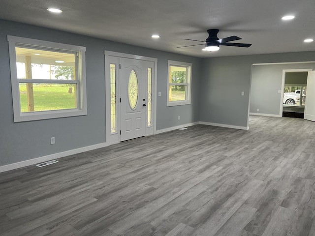 foyer with light hardwood / wood-style flooring and ceiling fan