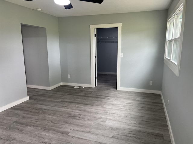 unfurnished room with ceiling fan and hardwood / wood-style floors