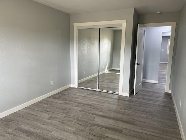 unfurnished bedroom with hardwood / wood-style floors and a closet